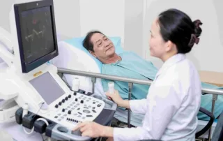 Bác sĩ Vinmec Cần Giờ đang thăm khám bệnh nhân với thiết bị y tế hiện đại, đạt tiêu chuẩn Cleveland Clinic.